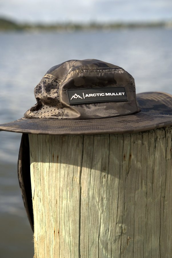 Grey camouflage hat on a dock post
